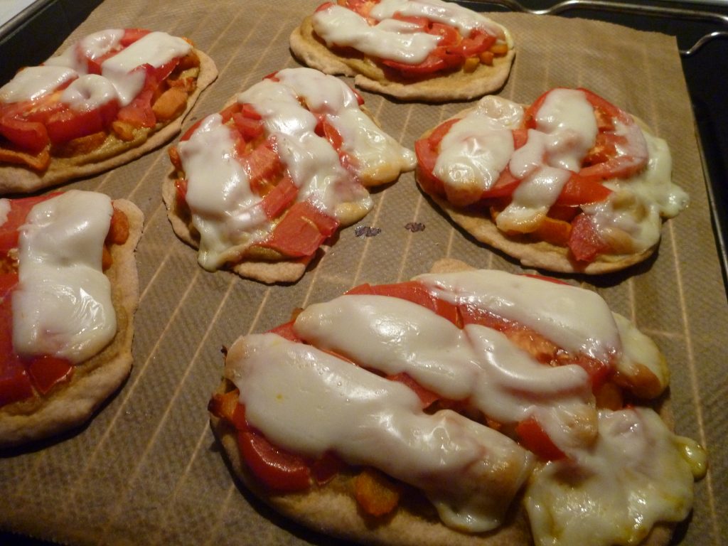 kleine Pizzen - Belegt mit Gemüse, Tomatenscheiben und Käse